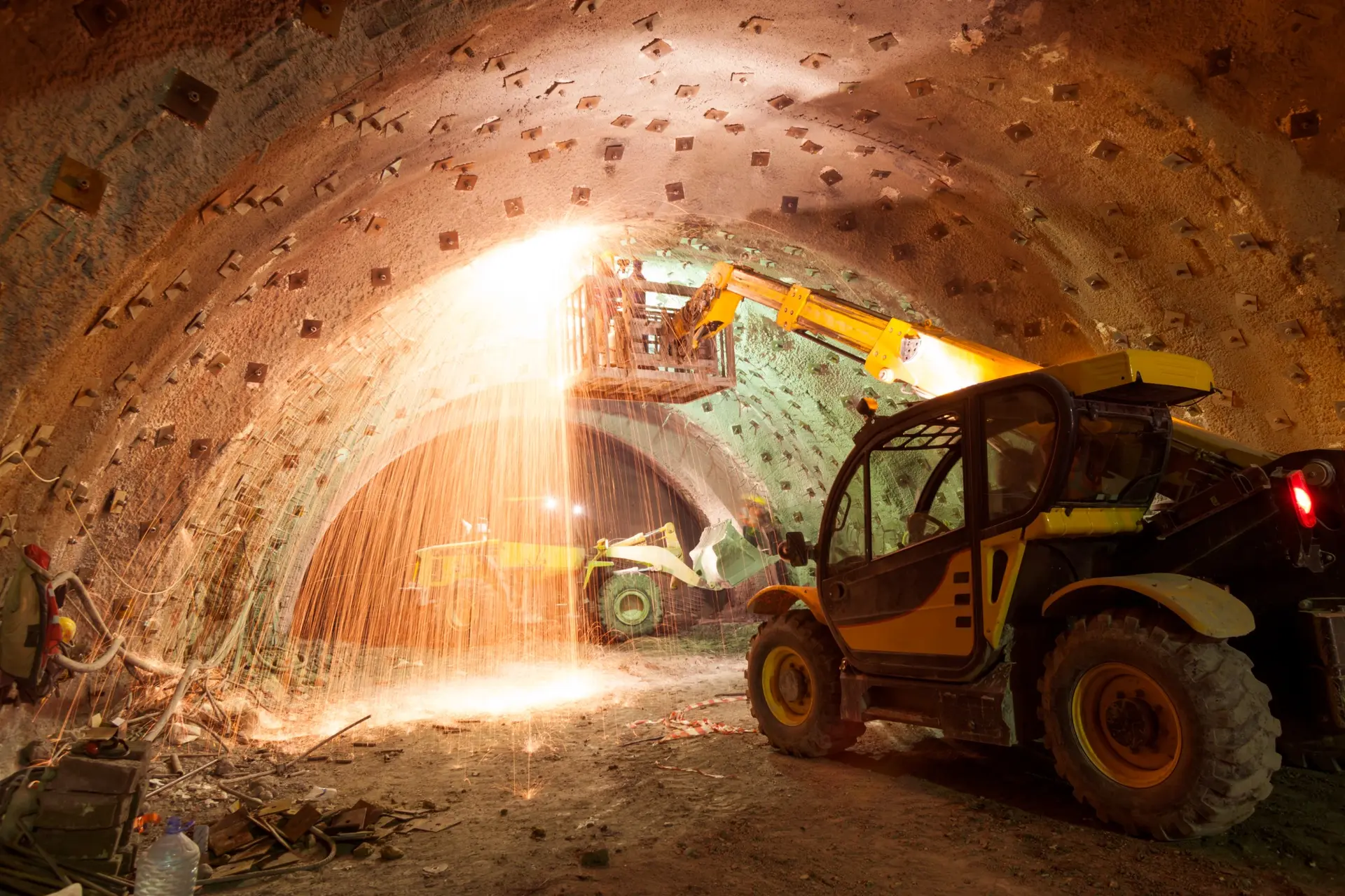 Construction equipment working inside an underground excavation.